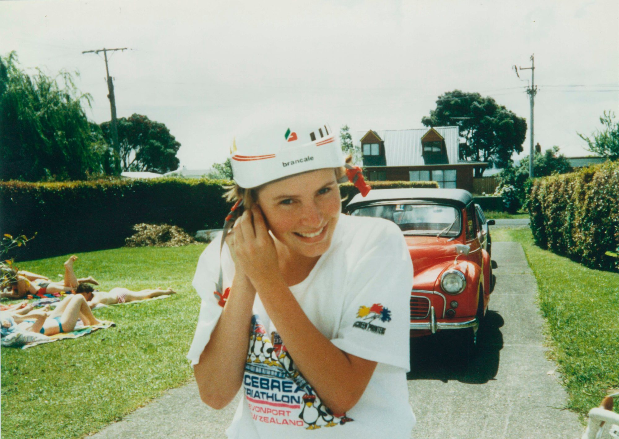 Sherilyn White smiling in a triathlon t-shirt and cycling cap